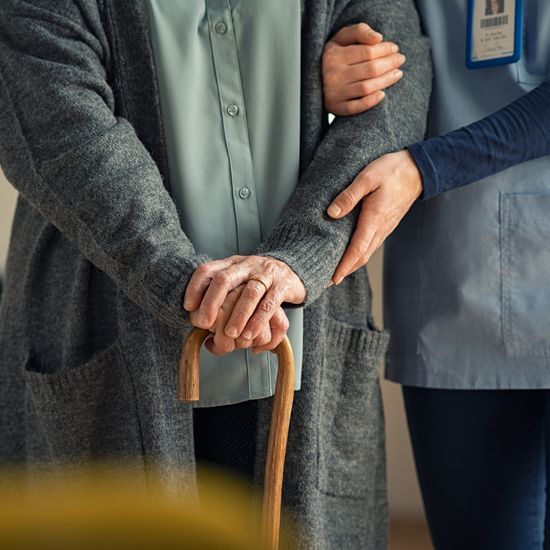 Caregiver supporting elderly woman at home – debunking home care myths