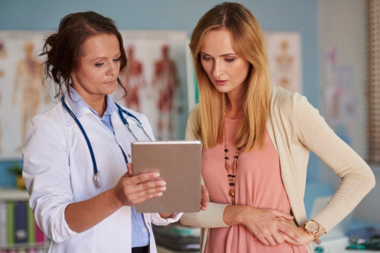After a breast cancer diagnosis, woman and support person preparing questions for an appointment
